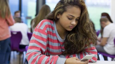 student with smartphone